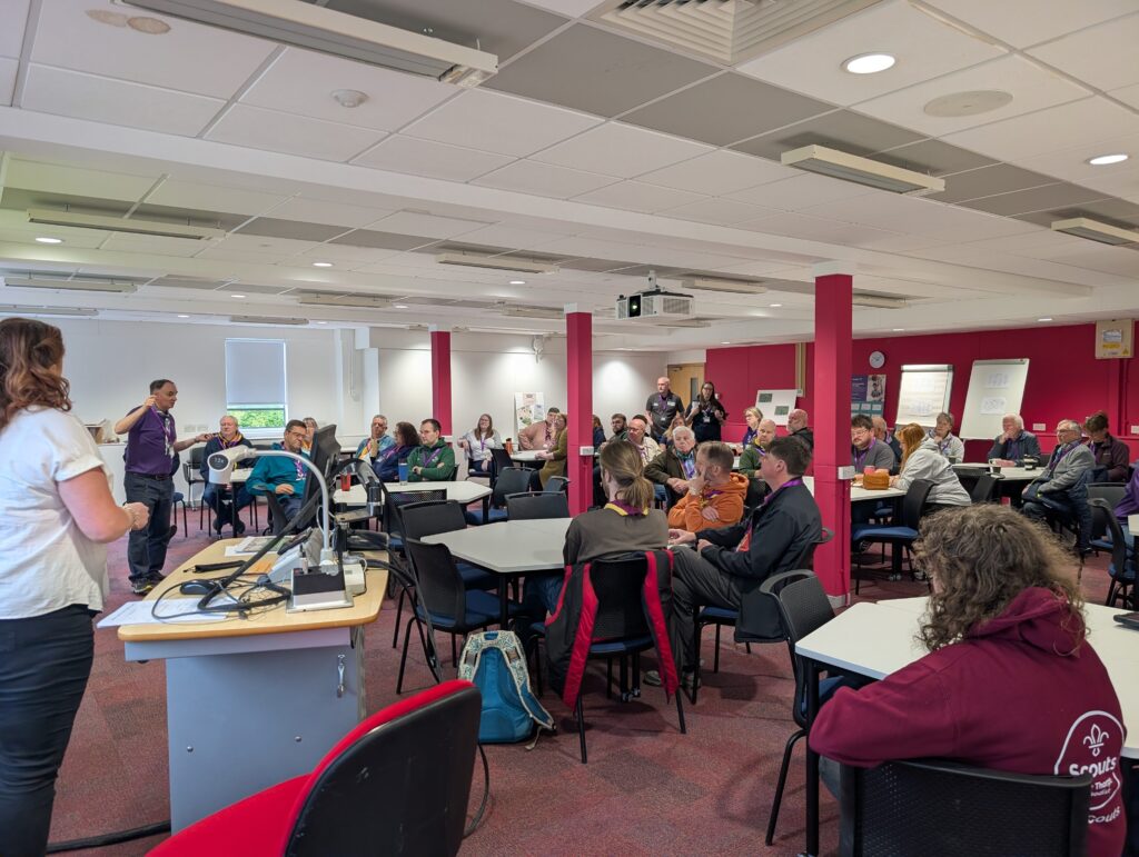 Picture from District Conference showing a group of scout leaders sitting listening to Nigel White