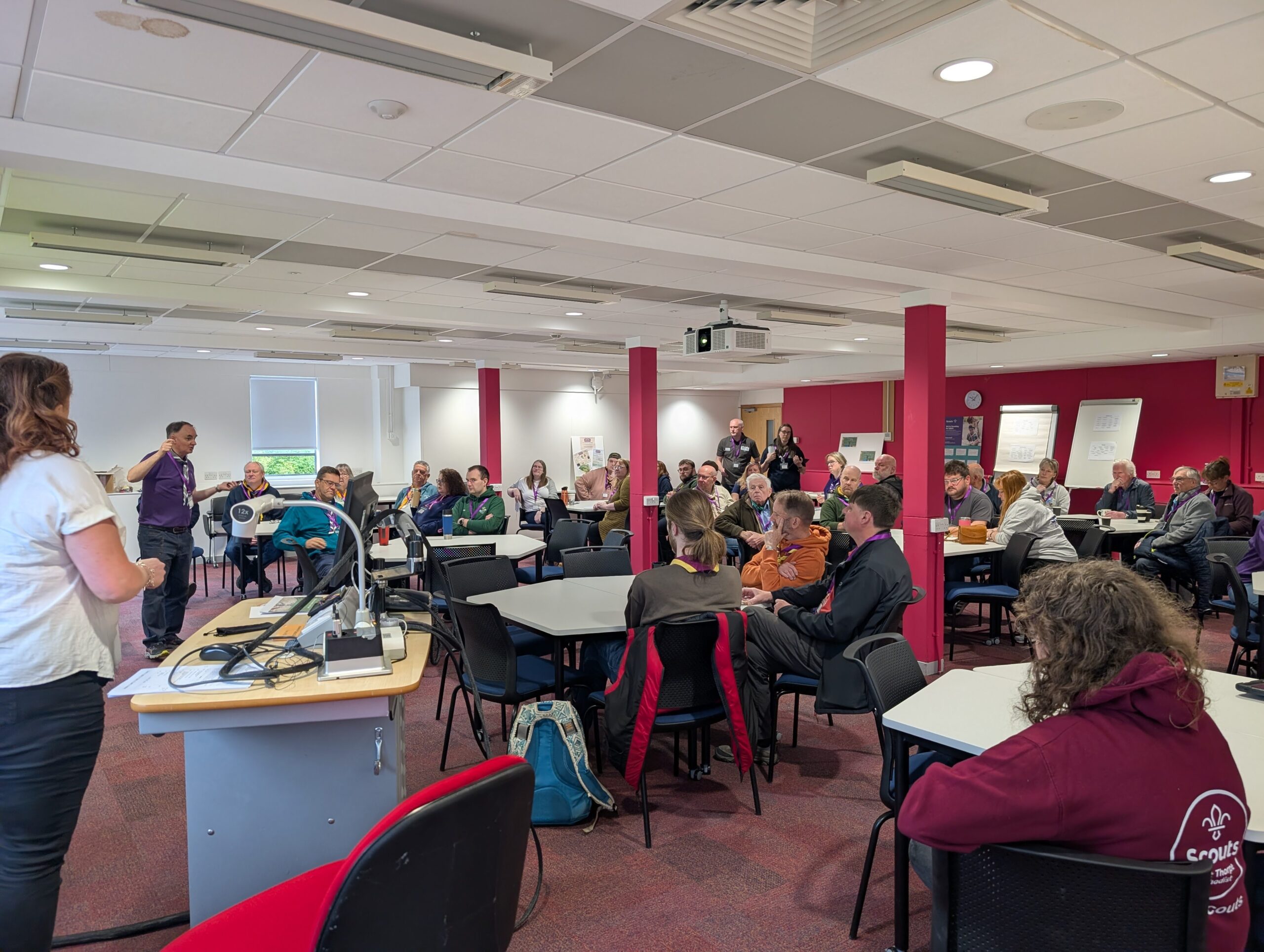 Picture from District Conference showing a group of scout leaders sitting listening to Nigel White
